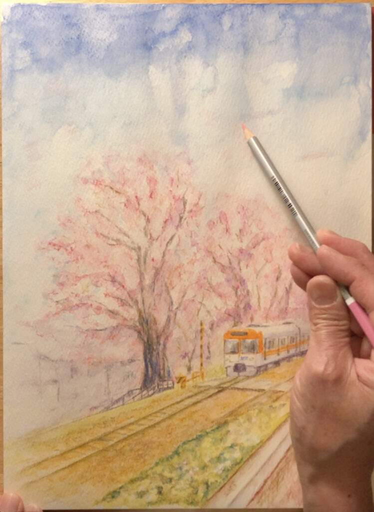 満開の桜の下を走る列車の絵