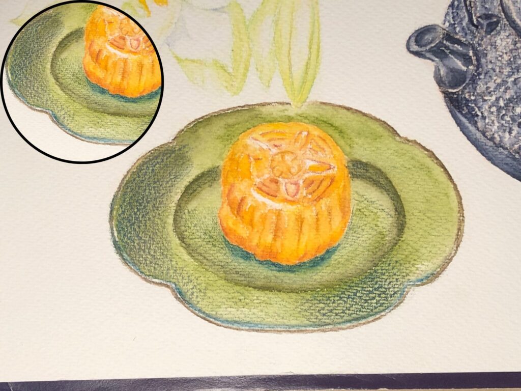 緑色のお皿に置かれた月餅を水彩色鉛筆で描いた絵