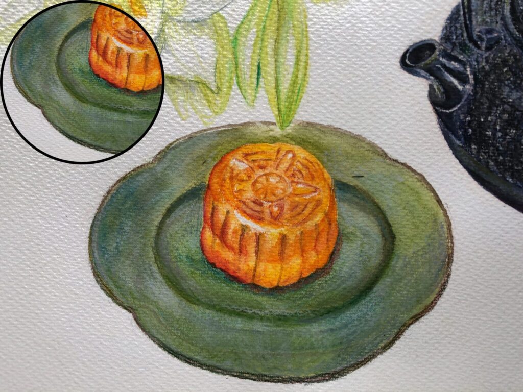 緑色のお皿に置かれた月餅を水彩色鉛筆で描いた絵